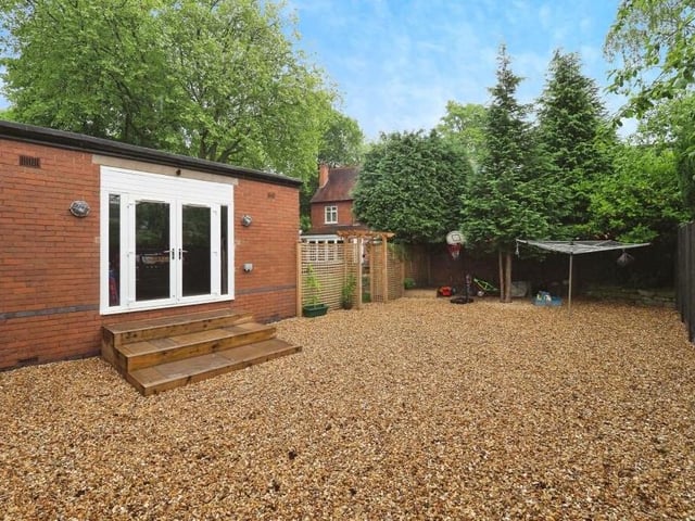 This final photo in our gallery shows the back of the garage or office, complete with French doors that lead on to a secret, hidden garden that has been fully gravelled.