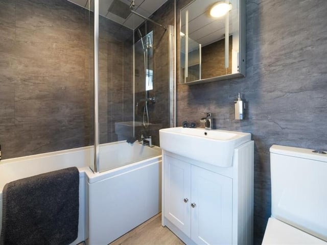 Here is the en suite bathroom to the master bedroom, with bath, shower, wash basin, storage and WC.