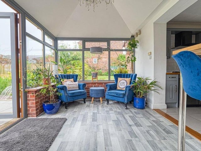 The entertainment room is a lovely spot in the Church Hill house, with views of and doors leading to the garden.