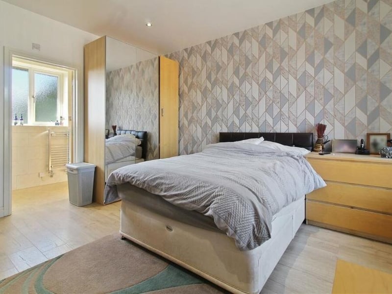 Wardrobe and storage space is a handy feature of this bedroom, which also has access to en suite facilities.