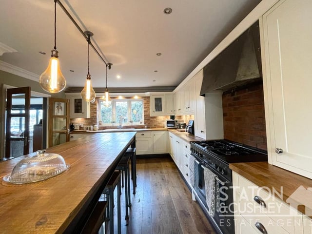 The kitchen/diner is equipped with a range of fitted wall and base units with drawers, plus a ceramic sink and drainer with hot tap, and also solid oak worktops.