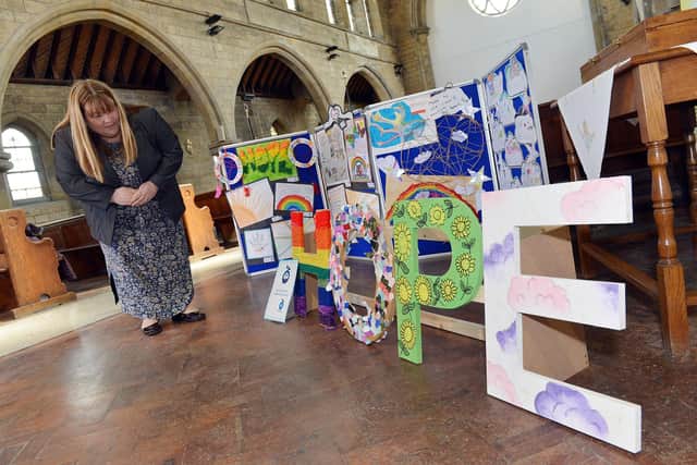 Shirebrook art installation by The HOPE project. 
Clare Draycott looking at one of the art pieces.