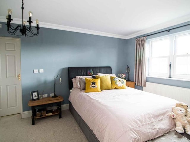 Moving upstairs, here is the main bedroom, which is a terrific size. It has two built-in wardrobes and access to an en suite bathroom.
