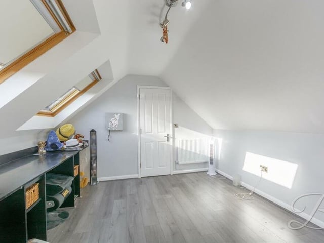 Another bedroom on the second floor also has access to an en suite shower room. A versatile space that could be used for other purposes, it has two Velux windows and a laminated floor.