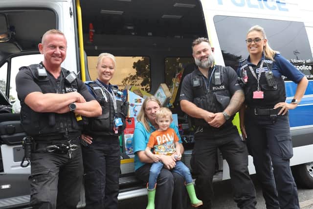 Police officers deliver toys for Harrison Smith.