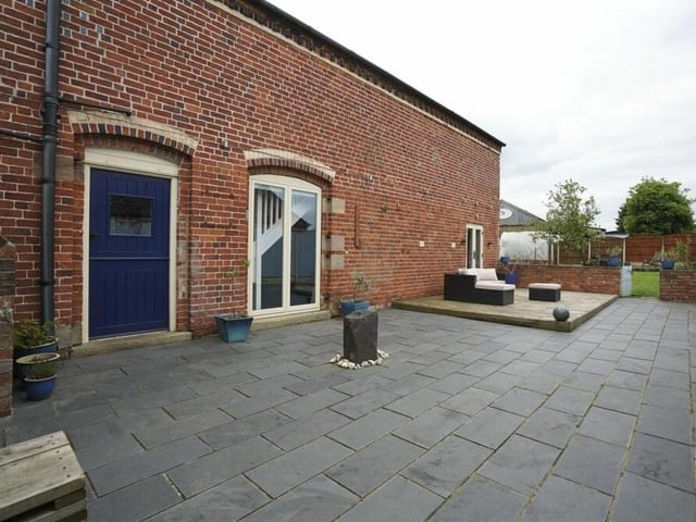A large patio area is a feature of one side of the property.
