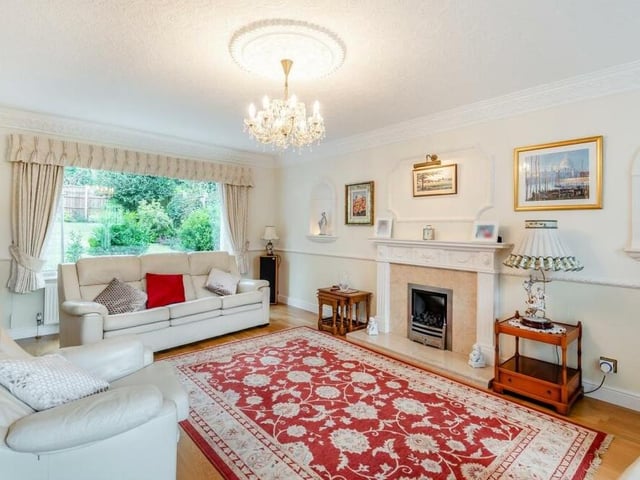 One of the main features of the lounge is a marble fireplace with inset coal-effect gas fire and an Adam-style surround. There are windows facing the front and back of the property.