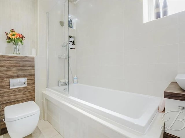 The family bathroom features a three piece suite comprising of a hand wash basin, low flush WC and a bath with an overhead shower for added convenience. Window to the side elevation.