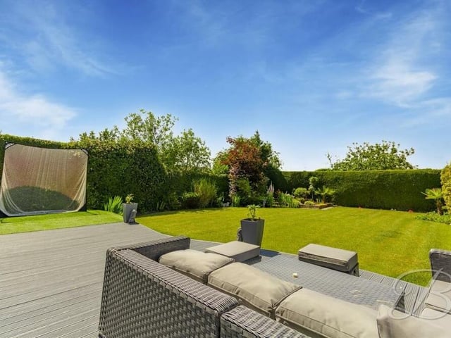 A closer look at the decked seating area in the rear garden of the Derby Road house. It looks out on to a stunning, pristine lawn.