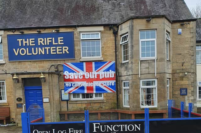 A 'Save Our Pub' banner is plastered across the front of the Rifle Volunteer in Skegby by campaigning residents.