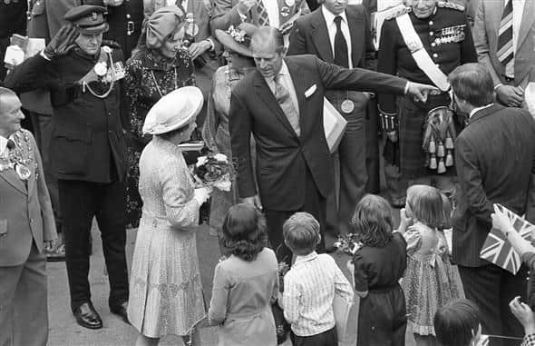 Prince Philip accompanies the Queen during a visit to Mansfield in 1977.