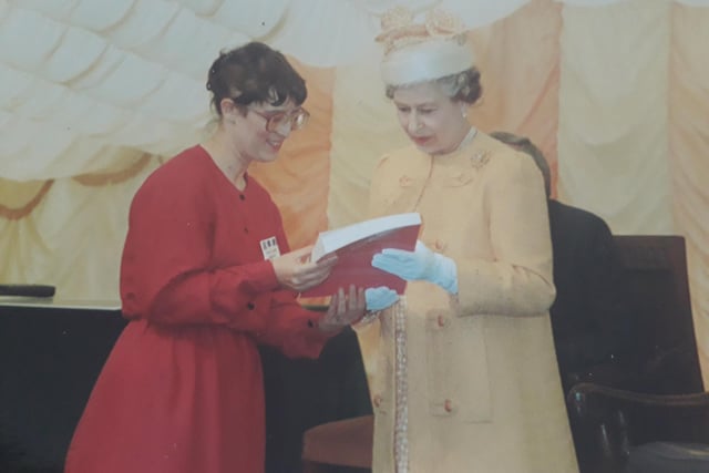 The Queen is shown a book on her visit to Portland College in 1990.