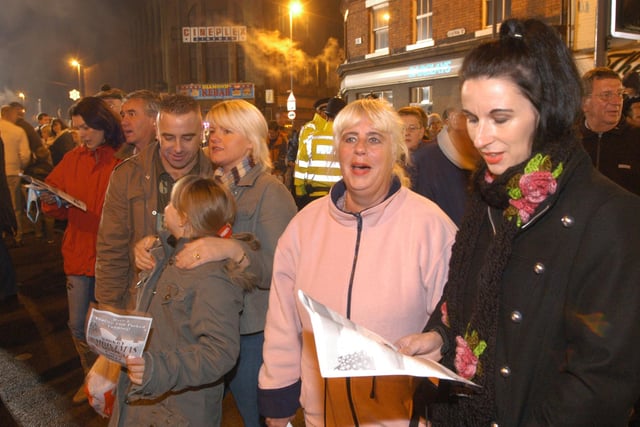 Visitors to the Kirkby Christmas Carnival in 2006 joining in the carol singing