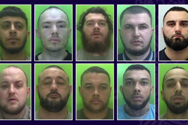 Some of the men involved in the firearm conversion operation.