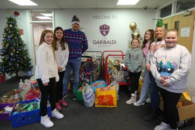 Pupils from The Garibaldi School visit the foodbank to hand over their donations 