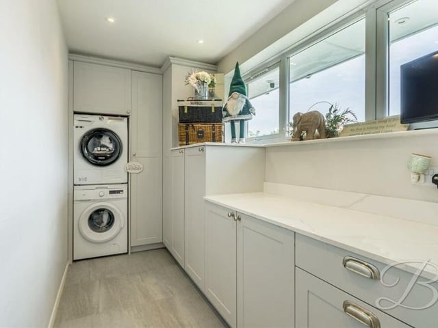 Not far from the kitchen/diner is this practical utility room, which is fitted with additional Shaker-style cabinets and work surfaces, and has plumbing for a washing machine and tumble dryer.