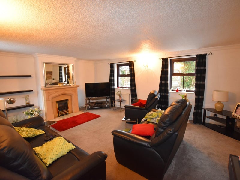 The dual-aspect lounge has a feature fireplace.