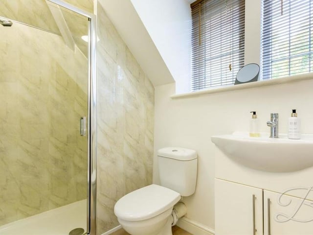 The annexe's compact shower room on the first floor of the house is fitted with an enclosed shower, wash hand basin and low-flush WC.
