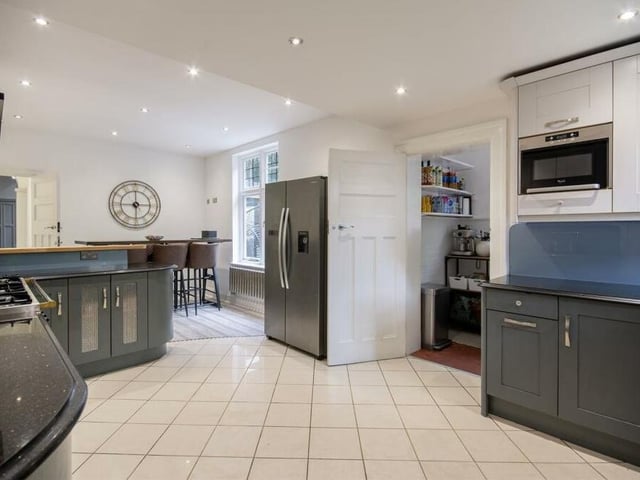 The kitchen at the £800,000 property is a stunner, particularly its range of wood shaker-style wall and base units and solid granite worktops. There is space for a free-standing cooker, while other assets include downlights, windows to the rear and side, and access to a pantry.