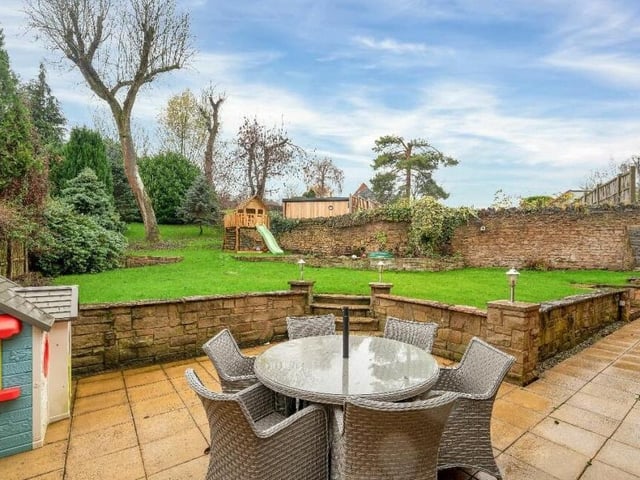 A seat on the patio offers a pleasant outlook, with steps leading to, and views of, the sizeable back garden.