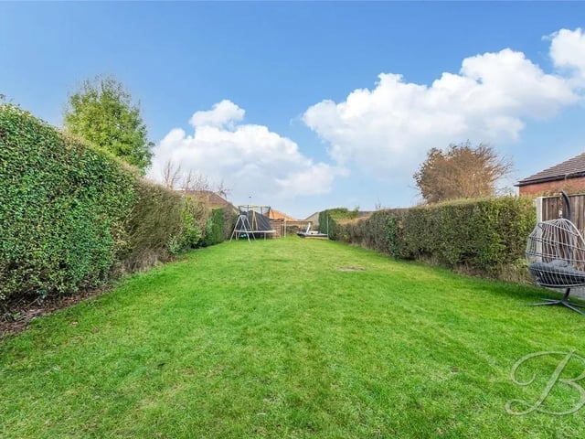 The property features an extensive and well-maintained lawn.