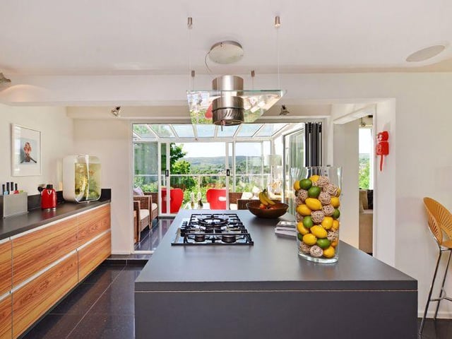Open plan living kitchen comprising of a "beautiful fitted kitchen", with polished tiled floor flowing into both the dining area and the conservatory.