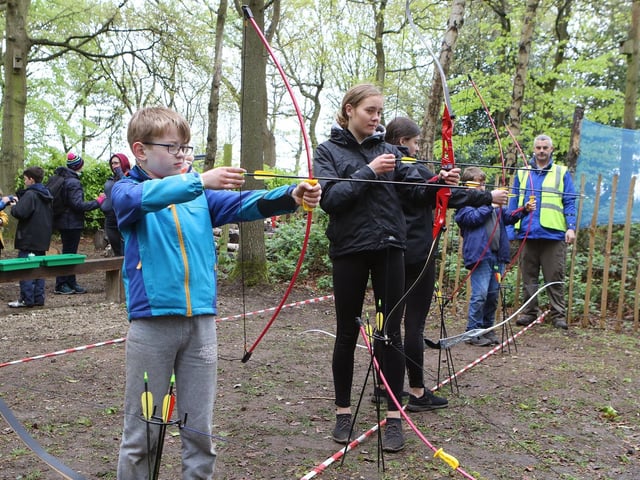 Mansfield scouts try their hand at archery at a scout camp.