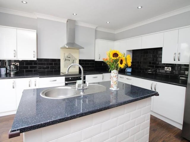 The dining kitchen also features an integrated electric oven and hob with extractor over. Doors lead to the lobby and the back garden, while there is open access to the conservatory.