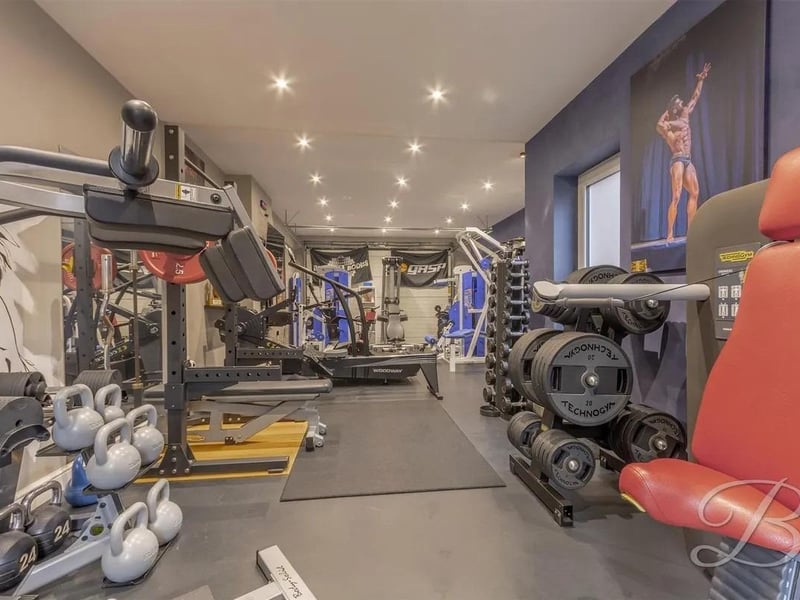 The attached garage has been fully transformed into a gym with rubber flooring.