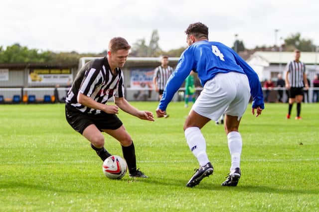 Midfielder Mitch Mullins takes on an opponent during a match for Clipstone last season.