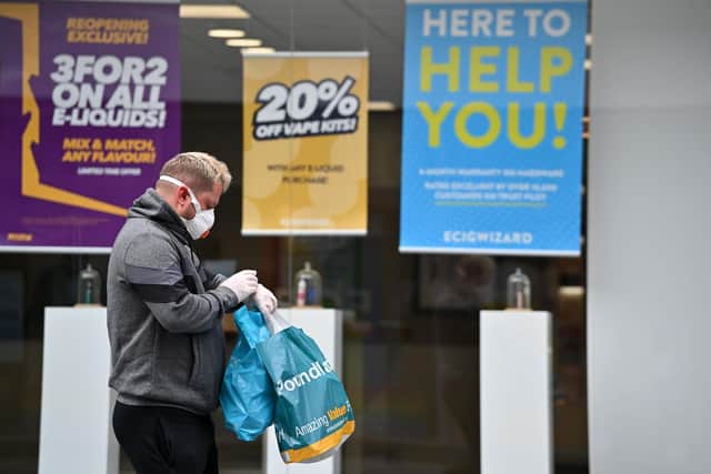Shoppers wearing PPE as a precautionary measure against spreading COVID-19  (Photo by JUSTIN TALLIS/AFP via Getty Images)