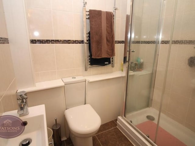 The shower room within the annexe comprises a three-piece suite made up of a shower cubicle, wall-mounted sink and WC, plus a chrome, heated towel-rail.