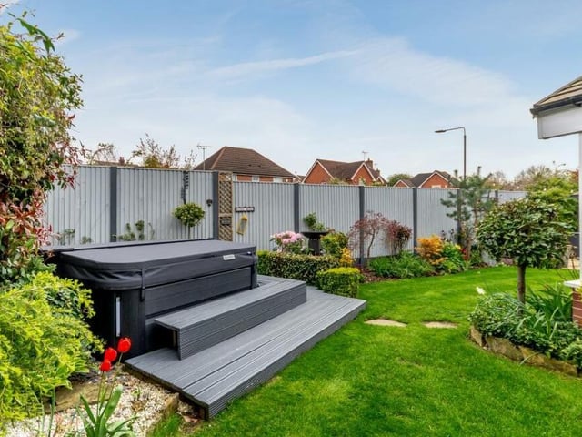 The back garden also includes a decked patio with steps that led to a hot tub, which is available to buy by separate negotiation.