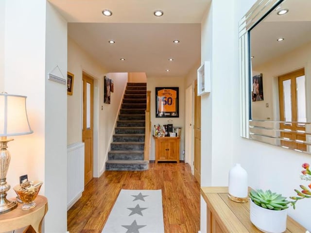 The main feature of the entrance hallway is this oak and glass staircase, which leads to a galleried landing on the first floor.