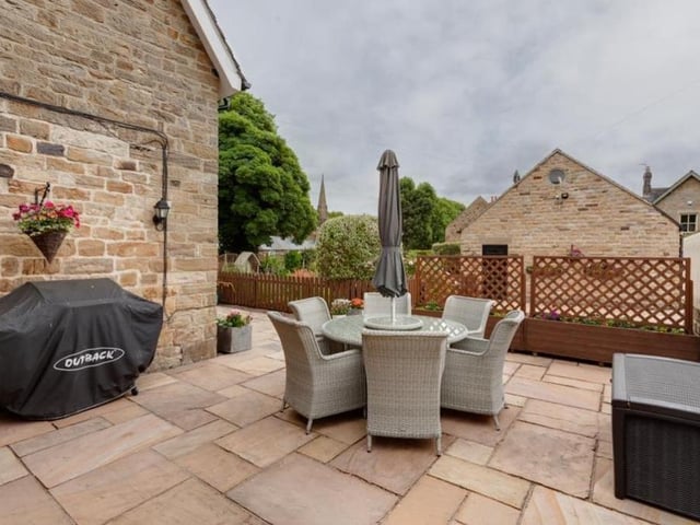The exterior of the Heath property is notable not only for its garden but also for this attractive seating area. A must for summer evenings and weekends with friends.