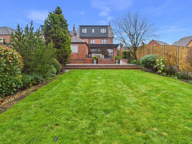 To the rear, a generous lawned garden creates the perfect setting for family activities and outdoor entertaining. The garden is bordered by mature planting, offering privacy and a pleasant outlook.