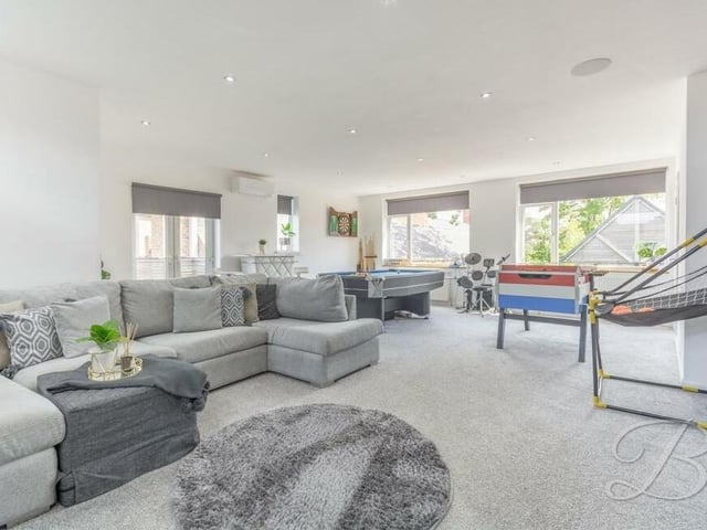 The fifth and final bedroom on the first floor, which has a balcony, has been successfully converted into this huge games room. But it could also be turned into an annexe space for a relative staying over, or reverted to a bedroom.