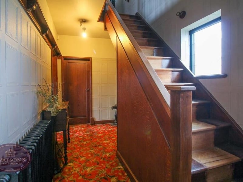It's time now to head to the first floor via this characterful staircase in the welcoming entrance hallway, which also features a built-in cloakroom and under-stairs storage.