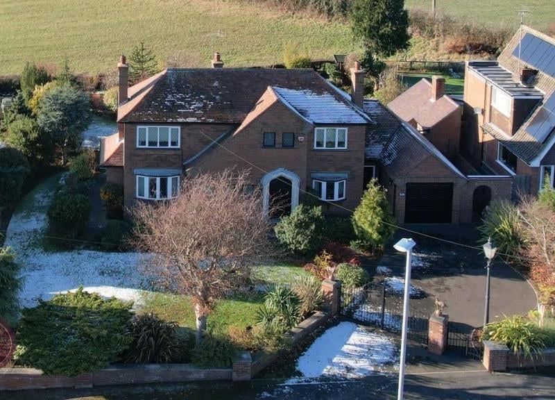 Our last image is an aerial shot from a drone, which shows how the impressive property sits on Nottingham Road. The front garden consists of a lawn, flowerbed borders, plants and shrubs.