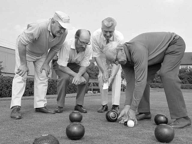 A group of Kirkby bowlers measure a shot back in 1970.