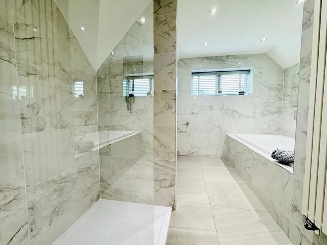 The main family bathroom is impressive with a large bath, walk-in shower and tiled walls and floor... a serene room to enjoy some me time.