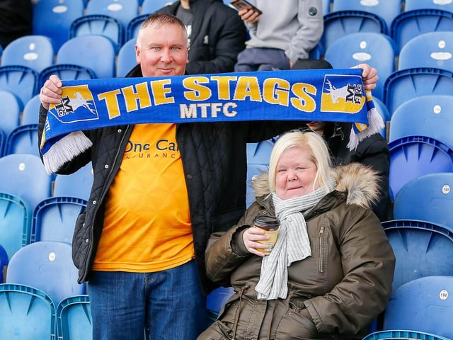 Mansfield Town fans watch the match against Northampton Town.