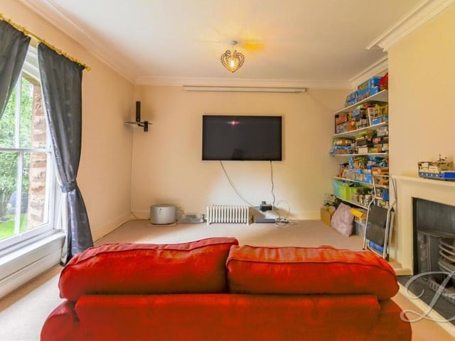 This bedroom, which also boasts a feature fireplace, has been turned into a cinema room with big screen