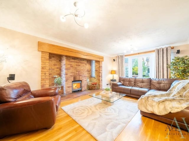 The main lounge featuring a stunning log burner and French doors out onto the garden, making it the perfect space to relax and unwind.