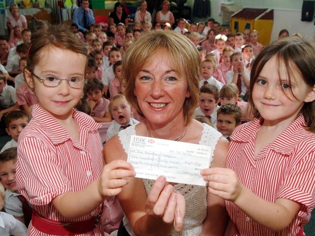 Pupils raised £147.22 for the Rainbow Children's Hospice through a 'Wrong Trousers Day'. Anna Jevons, left, and Alissia Boath, right, present the cheque to community fundraiser for the hospice, Caroline Hoare.