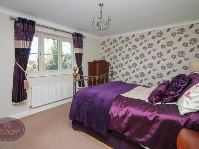 Moving now into the third bedroom, which also overlooks the back of the property. It boasts sliding-door wardrobes.