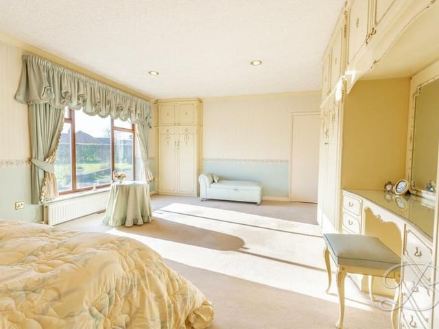 A second image of the main bedroom at the £580,000 bungalow, with its extensive range of furniture and storage. It has access to the family bathroom too.