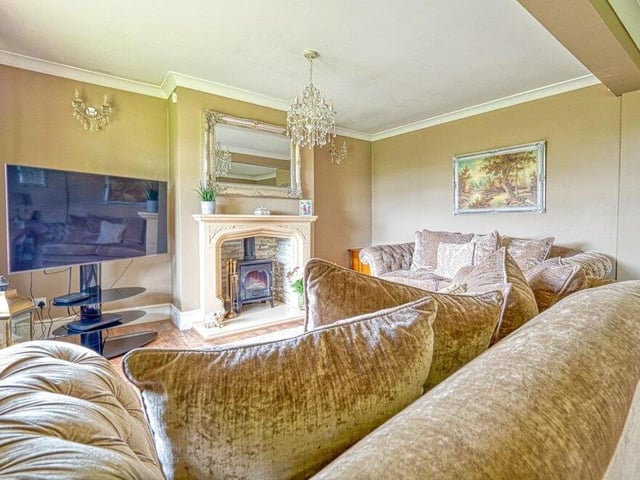 The first of the main ground-floor rooms to look at is this lounge diner, which has been transformed by the current owners. It has been brought to life by a wood-burning fireplace, stone-effect surround and mantelpiece.