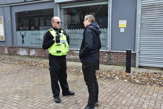 Coun Helen-Ann Smith chats with an anti-social behaviour officer in front of a business premises