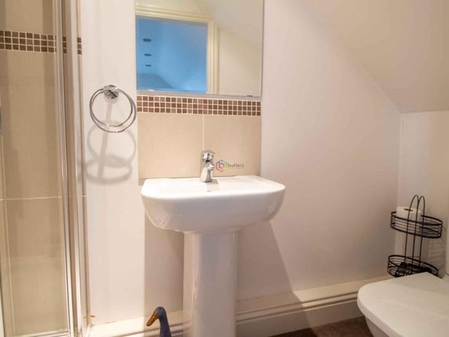 The second en suite bathroom at the £500,000 property links to the fifth bedroom and the biggest of two attic rooms. It is fitted with a shower cubicle, white wash hand basin and WC.